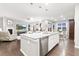 Open concept living space featuring a kitchen island, dining area and living room at 18922 W 84Th Ave, Arvada, CO 80007