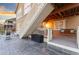 Backyard patio with seating area and stairs leading to an upper deck with a swing at 18922 W 84Th Ave, Arvada, CO 80007