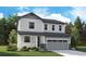Charming two-story home with gray siding, large windows, and a two-car garage at 2644 Simpson Ln, Erie, CO 80026
