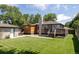 Large backyard featuring lush grass, a deck, and a detached garage at 2995 N Cherry St, Denver, CO 80207