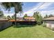 Spacious backyard with green grass and a dark fence at 2995 N Cherry St, Denver, CO 80207