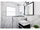 Modern bathroom with a stylish vanity, sleek fixtures, and marble-like tiling at 2995 N Cherry St, Denver, CO 80207