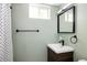 Small bathroom featuring sage colored walls, a dark vanity, and a shower curtain at 2995 N Cherry St, Denver, CO 80207