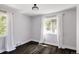 Bright bedroom featuring hardwood floors, light walls, and a ceiling light fixture at 2995 N Cherry St, Denver, CO 80207