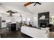 Inviting living room with stacked stone fireplace, modern lighting, and open flow to the kitchen and dining areas at 2995 N Cherry St, Denver, CO 80207