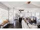 Open-concept living room showcasing dark hardwood floors, modern furnishings, and seamless flow to the kitchen at 2995 N Cherry St, Denver, CO 80207