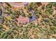 Aerial view of home nestled among trees, featuring circular driveway and serene outdoor amenities at 7790 S Homesteader Dr, Morrison, CO 80465