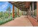 Spacious back porch featuring wooden posts and scenic views of the lush green landscape and blue sky at 7790 S Homesteader Dr, Morrison, CO 80465