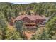 Expansive back deck and patio with seating, perfect for enjoying the serene mountain views and outdoor living at 7790 S Homesteader Dr, Morrison, CO 80465