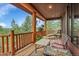 Inviting balcony with wooden railings and seating offers beautiful views of the surrounding landscape at 7790 S Homesteader Dr, Morrison, CO 80465