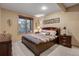 Warm bedroom with a large bed, dark wood furniture, and a window with natural light, creating a relaxing atmosphere at 7790 S Homesteader Dr, Morrison, CO 80465