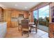 Breakfast nook featuring wood cabinetry, a table with chairs, and a large window with scenic views at 7790 S Homesteader Dr, Morrison, CO 80465