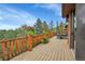 Exterior deck with railing offers scenic views of the surrounding evergreen landscape at 7790 S Homesteader Dr, Morrison, CO 80465