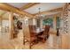 Inviting dining room with log beam ceiling, hardwood floors, large windows, and an ornate chandelier at 7790 S Homesteader Dr, Morrison, CO 80465