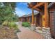 Inviting front entrance with stone and wood accents and a brick walkway, creating a warm welcome at 7790 S Homesteader Dr, Morrison, CO 80465