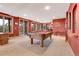 Spacious game room featuring a pool table, bar area, and access to the outdoors at 7790 S Homesteader Dr, Morrison, CO 80465