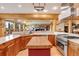 Bright kitchen with wood cabinets, stainless appliances, butcher block island, and open view of living area at 7790 S Homesteader Dr, Morrison, CO 80465