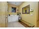 Bright laundry room with white cabinets, storage bench, and a convenient utility sink at 7790 S Homesteader Dr, Morrison, CO 80465