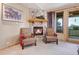 Cozy living room features a stone fireplace with a log mantle and balcony access at 7790 S Homesteader Dr, Morrison, CO 80465