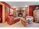 Inviting living room features a stone fireplace, wooden shelving, and comfortable seating for a cozy retreat at 7790 S Homesteader Dr, Morrison, CO 80465