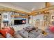 Cozy living room with a stone fireplace, comfortable seating, and rustic accents, creating a warm atmosphere at 7790 S Homesteader Dr, Morrison, CO 80465