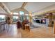 Comfortable living room featuring a stone fireplace, hardwood floors, and mountain views through large windows at 7790 S Homesteader Dr, Morrison, CO 80465