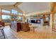 Spacious living room with a stone fireplace, wood beams, and large windows, offering natural light and views at 7790 S Homesteader Dr, Morrison, CO 80465