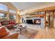 Inviting living room with a stone fireplace, ample seating, and scenic views, blending comfort and nature at 7790 S Homesteader Dr, Morrison, CO 80465