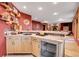 Entertainment space featuring a wet bar with custom cabinetry and beverage cooler, ideal for hosting gatherings at 7790 S Homesteader Dr, Morrison, CO 80465