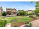 Expansive backyard features a well-kept lawn, mature trees, landscaping, and a patio for outdoor enjoyment at 10546 Sundial Rim Rd, Highlands Ranch, CO 80126