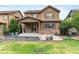 Charming backyard with a lush lawn, mature trees, a cozy patio, and attractive landscaping at 10546 Sundial Rim Rd, Highlands Ranch, CO 80126