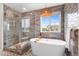 Modern bathroom with freestanding tub, large windows, and stylish shower with glass door at 10546 Sundial Rim Rd, Highlands Ranch, CO 80126