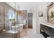 Bathroom featuring modern tub and shower with glass surround and beautiful patterned tile floors at 10546 Sundial Rim Rd, Highlands Ranch, CO 80126