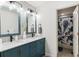 Bathroom with dual vanity, updated fixtures, modern lighting, and door to a shower with whale-themed curtain at 10546 Sundial Rim Rd, Highlands Ranch, CO 80126