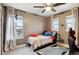 Bedroom featuring three windows with modern curtains, ceiling fan, and neutral wall color at 10546 Sundial Rim Rd, Highlands Ranch, CO 80126