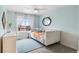 Bright bedroom with a large window and white curtains and daybed with colorful pillows at 10546 Sundial Rim Rd, Highlands Ranch, CO 80126