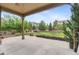 Spacious covered patio overlooking the beautifully landscaped backyard and lush greenery at 10546 Sundial Rim Rd, Highlands Ranch, CO 80126