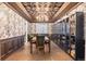 Elegant dining room with ornate ceiling, sophisticated wallpaper, and ample built-in shelving for storage and display at 10546 Sundial Rim Rd, Highlands Ranch, CO 80126