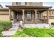 Inviting front porch with decorative columns, beautiful planters, and charming curb appeal at 10546 Sundial Rim Rd, Highlands Ranch, CO 80126