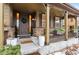 Charming front porch with stone accents, decorative plants, and a welcoming entrance for a cozy curb appeal at 10546 Sundial Rim Rd, Highlands Ranch, CO 80126