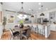 Bright eat-in kitchen boasts an island with bar seating, stainless appliances, and modern pendant lighting at 10546 Sundial Rim Rd, Highlands Ranch, CO 80126