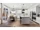 Open-concept kitchen and dining area with hardwood floors, white cabinets, and a view to the outdoor patio at 10546 Sundial Rim Rd, Highlands Ranch, CO 80126