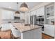 Modern kitchen features white cabinets, stainless steel appliances, an island, and hardwood floors at 10546 Sundial Rim Rd, Highlands Ranch, CO 80126