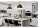 Bright kitchen with white cabinets, stainless steel appliances, and a large center island with pendant lighting at 10546 Sundial Rim Rd, Highlands Ranch, CO 80126