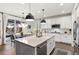 Modern kitchen with white cabinets, stainless steel appliances, and a large center island perfect for Gathering meals and entertaining at 10546 Sundial Rim Rd, Highlands Ranch, CO 80126