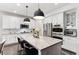 Bright kitchen with a marble island, stainless steel appliances, and seating for casual dining, with a door in the background at 10546 Sundial Rim Rd, Highlands Ranch, CO 80126