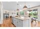 Open concept kitchen featuring an island with seating, stainless steel appliances, and access to the living room at 10546 Sundial Rim Rd, Highlands Ranch, CO 80126