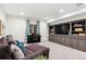 Inviting living room featuring a cozy sofa, custom built-ins, and natural light at 10546 Sundial Rim Rd, Highlands Ranch, CO 80126