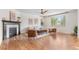 Inviting living room with hardwood floors, fireplace, large windows, and ceiling fan at 10546 Sundial Rim Rd, Highlands Ranch, CO 80126