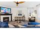 Cozy living room featuring a fireplace, neutral decor, and lots of natural light from the adjacent windows at 10546 Sundial Rim Rd, Highlands Ranch, CO 80126